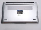 a close up of a silver laptop with a blue button