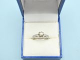 a diamond ring in a blue box on a blue surface