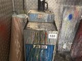 a dirty furnace in the corner of a room