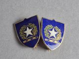 two lapel pins with a star and wreath on them