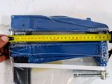 a person holding a tape measure in front of a piece of plastic