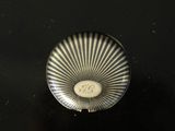 a close up of a silver object on a black surface