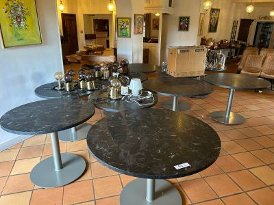 a room with tables and chairs in it and a painting on the wall