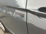 a close up of a car door handle with a sticker on it