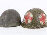 two helmets are sitting next to each other on a white surface