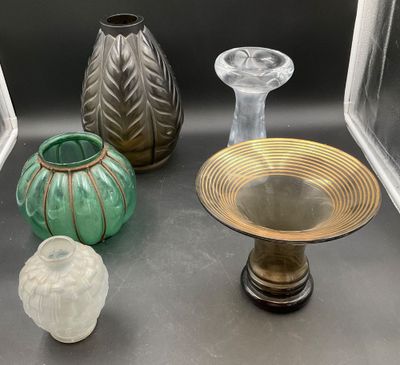 three vases and a bowl sitting on a table
