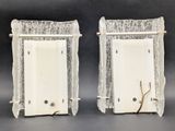 pair of silver and glass bookends with a crack in the middle