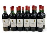 six bottles of wine are lined up in a row on a white surface