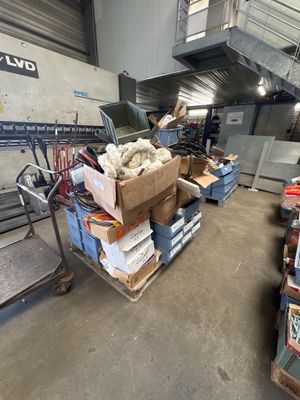 a large pile of boxes and boxes on a cart in a warehouse