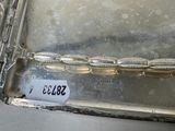 a picture of a silver tray with a label on it