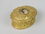 a gold box with a picture of a woman on it