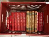 many books in a red box on the shelf