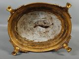a gold plate with a handle on a white background