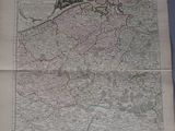 an old map on a table with a person standing in front of it