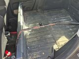 the back of a car with a broken battery in it ' s trunk