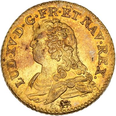 gros plan d'une pièce d'or sur laquelle figure une femme