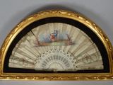 an old fan with a painting on it hanging on a wall