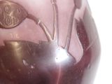 a vase with a design on it sitting on a table