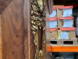 a wooden cabinet that has a gold handle on it
