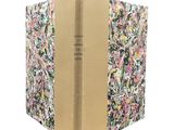 an open book with a floral cover on a white background