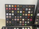 a lot of different types of buttons in a display case