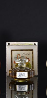 a small glass jar of honey next to a small glass jar of honey