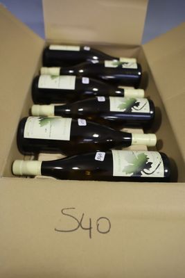 six bottles of wine in a cardboard box with a price tag