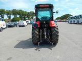 a tractor that is parked in a parking lot