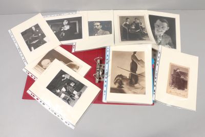 a lot of old black and white photos on a table