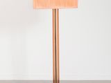 the floor lamp is made of wood and has a pink shade