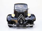 a very old car that is sitting on a white surface