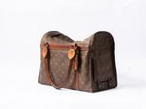 a brown and tan bag sitting on a white surface