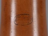 a close up of a wooden vase with a bird on it