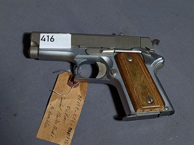 a gun with a tag attached to it sitting on a table