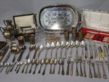 a lot of silverware on a table with a mirror
