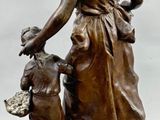bronze statue of a woman with a dog on a marble base