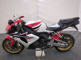 a red and white motorcycle parked on a black and white checkered floor
