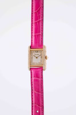 a very pretty pink watch with a diamond bezeled face
