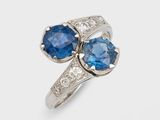 a close up of two blue sapphire and diamond rings on a white background