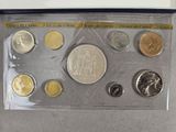 an assortment of coins in a plastic case on a table