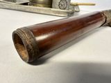 a wooden pipe sitting on a table next to a silver tray