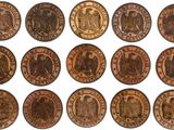 a close up of a bunch of coins on a white surface