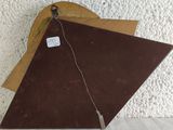 a brown piece of wood with a tag on it