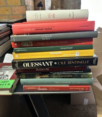 several books are stacked on top of each other on a table