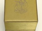 a gold box with a picture of a horse on it