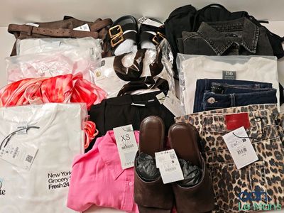 de nombreux types de vêtements et de sacs différents posés sur la table