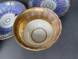 three cups and saucers sitting on a table
