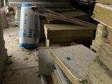 a pile of wood stacked on top of each other in a room