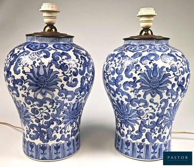 pair of blue and white vases with floral designs on them