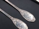 two spoons that are sitting on a table